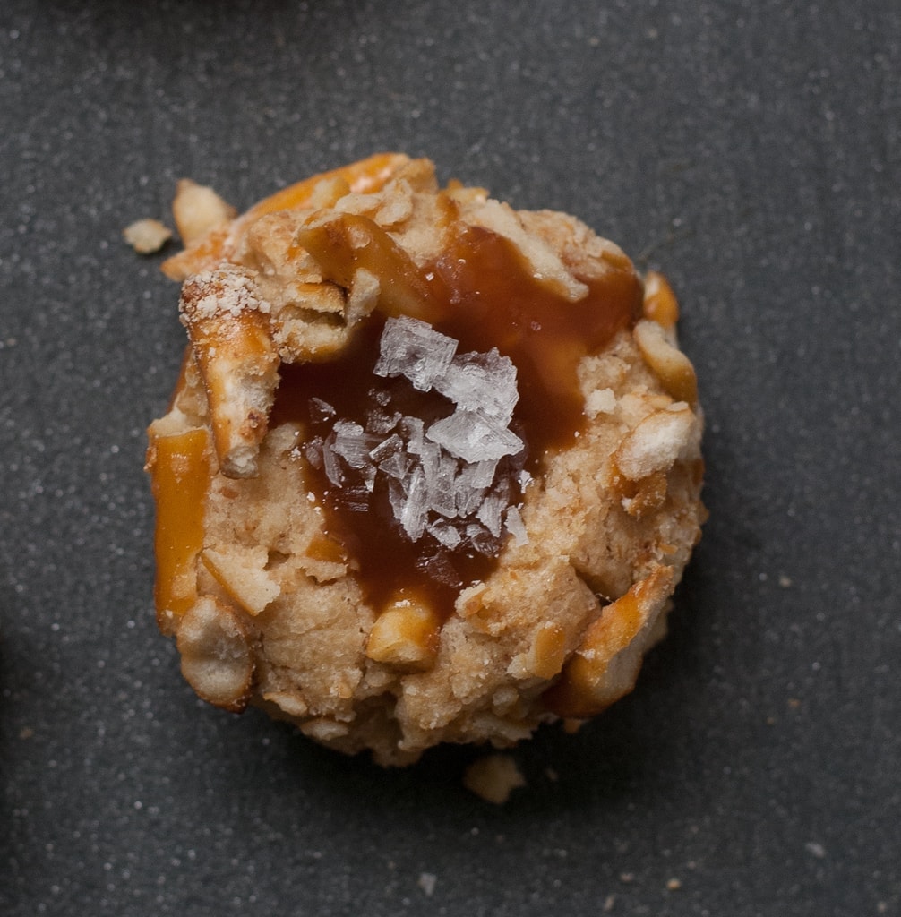 pretzel thumbprint cookies filled with caramel sprinkled with salt