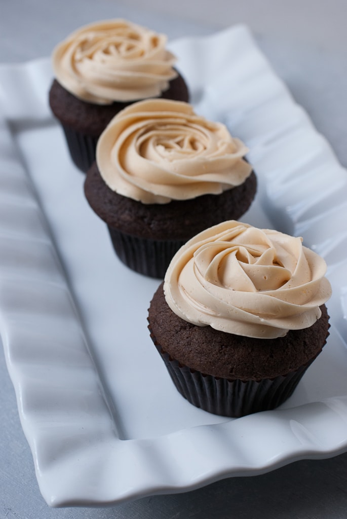 Dark Chocolate Cupcakes With Salted Caramel Buttercream on a white plate