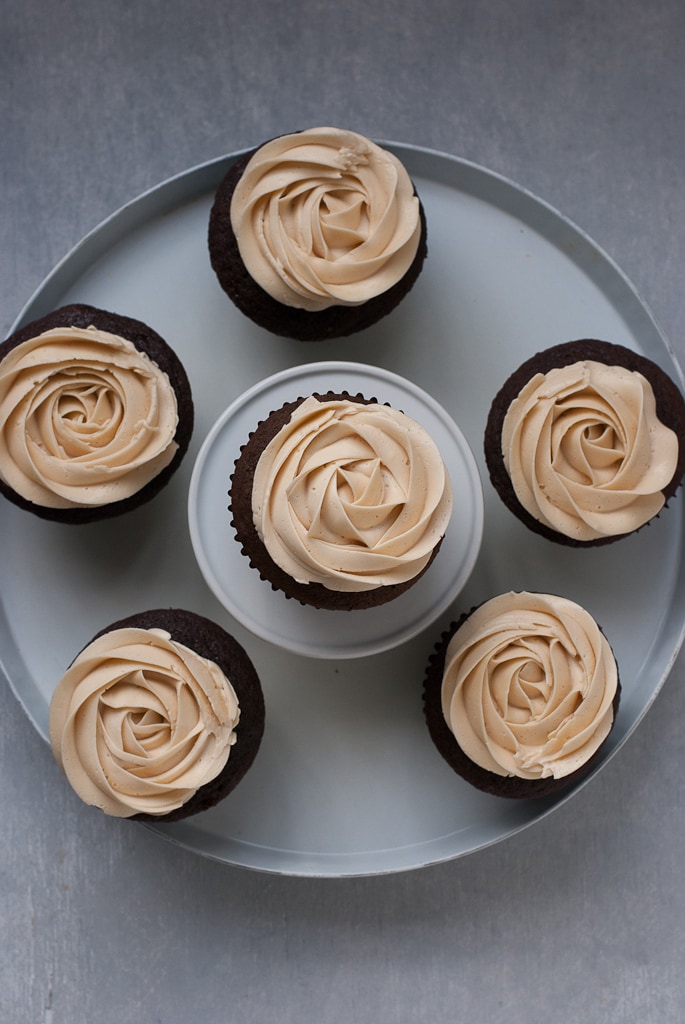 Dark Chocolate Cupcakes With Salted Caramel Buttercream on a white plate