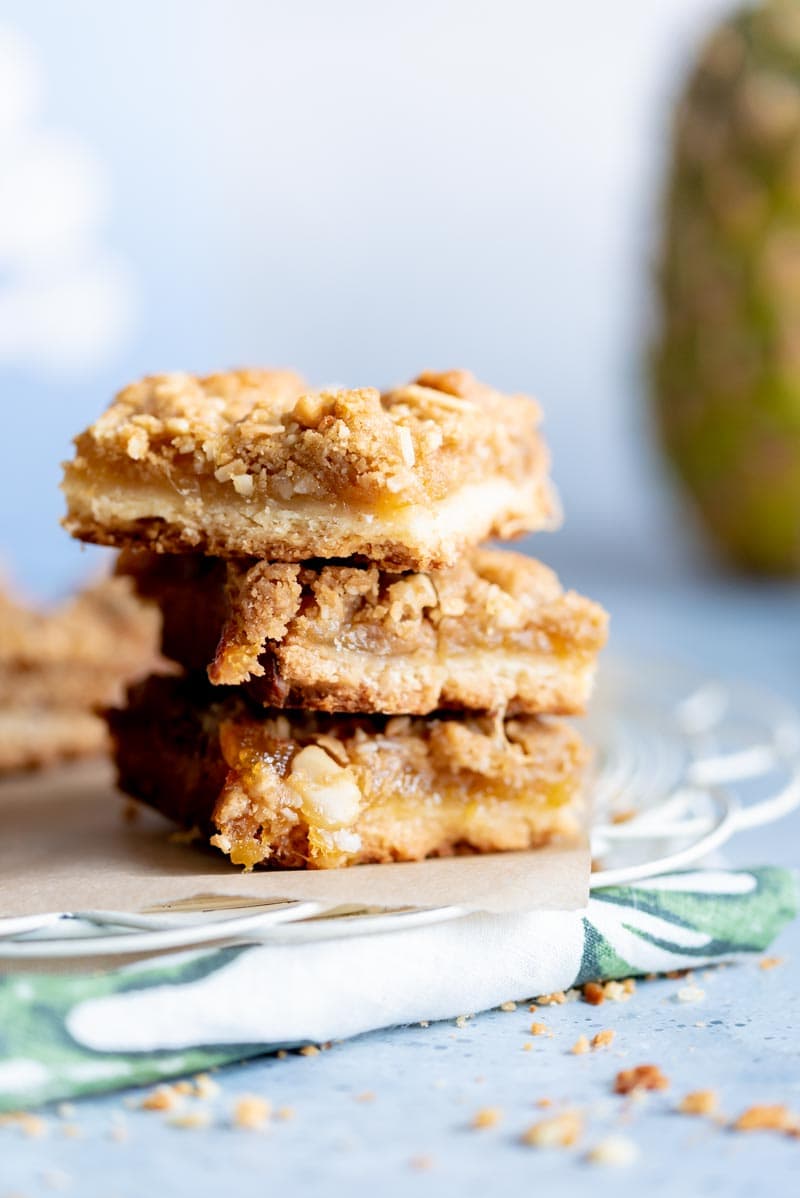  Tropical Jammy Pie Bars adapted from Hummingbird High's baking book "Weenight Baking". Made with mango pineapple jam and a coconut macadamia nut streusel. www.pineappleandcoconut.com