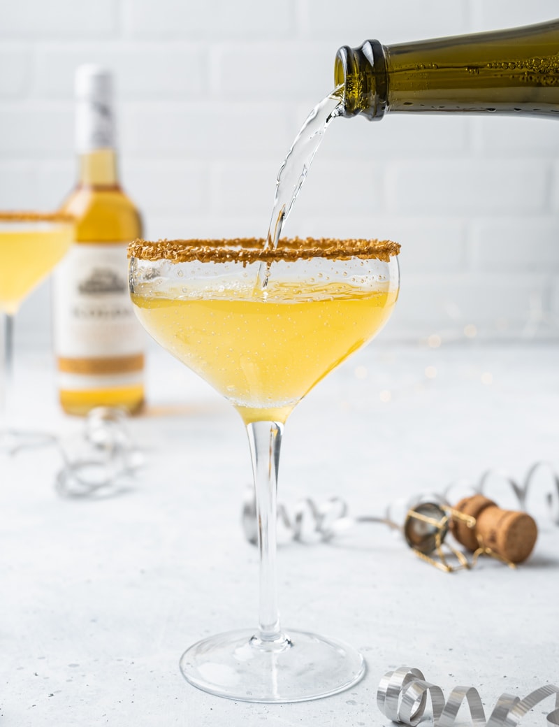 New Year’s Golden Tiki Cocktail ( Gold Rum Lychee Champagne Cocktail) Pour pic www.pineappleandcoconut.com