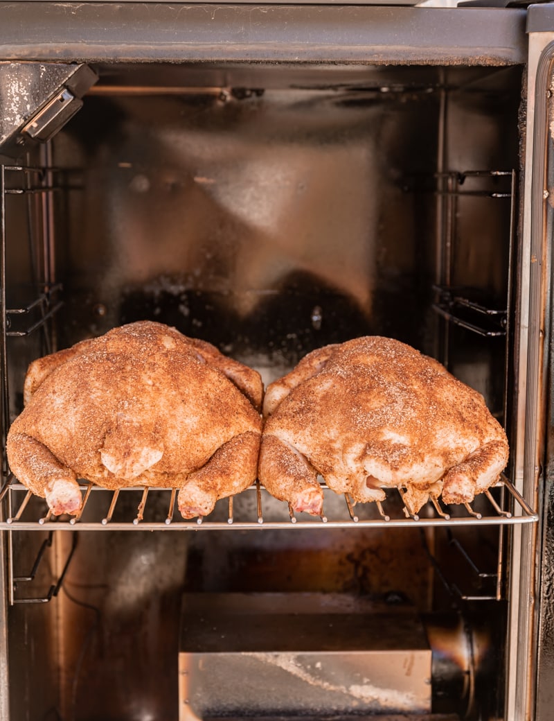 spice seasoned raw chickens in smoker