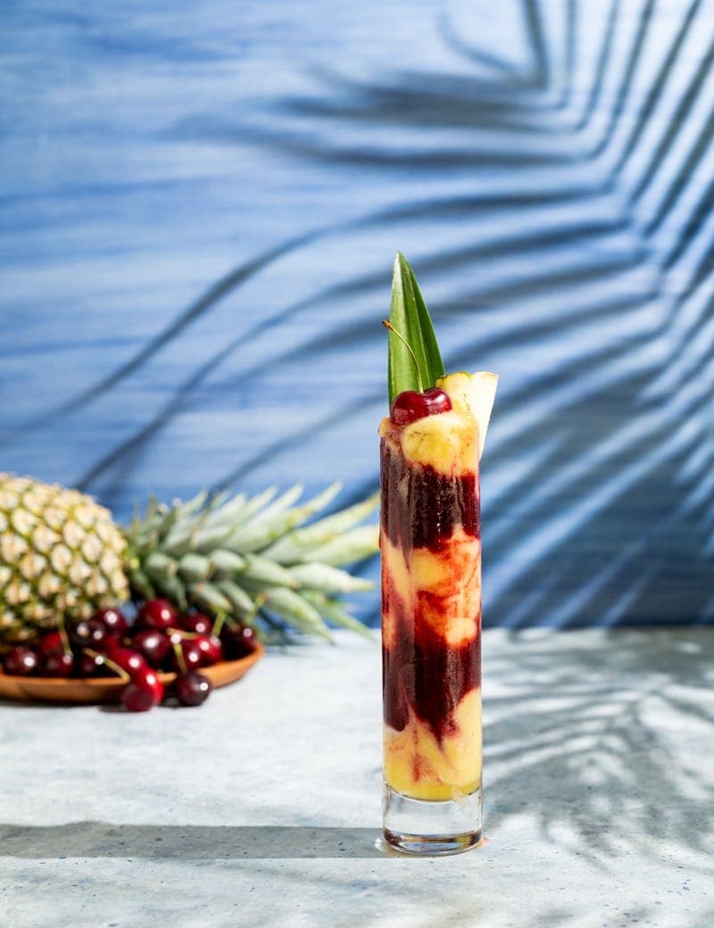 Big Stick Cocktail Layered Frozen Pineapple Cherry Cocktail www.pineappleandcoconut.com