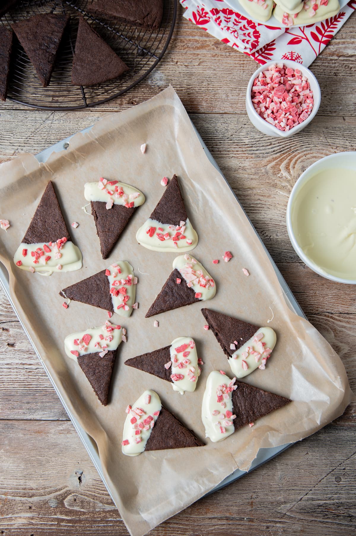 chocolate wedge shortbread cookies half dipped in white chocolate sprinkled with peppermint bits