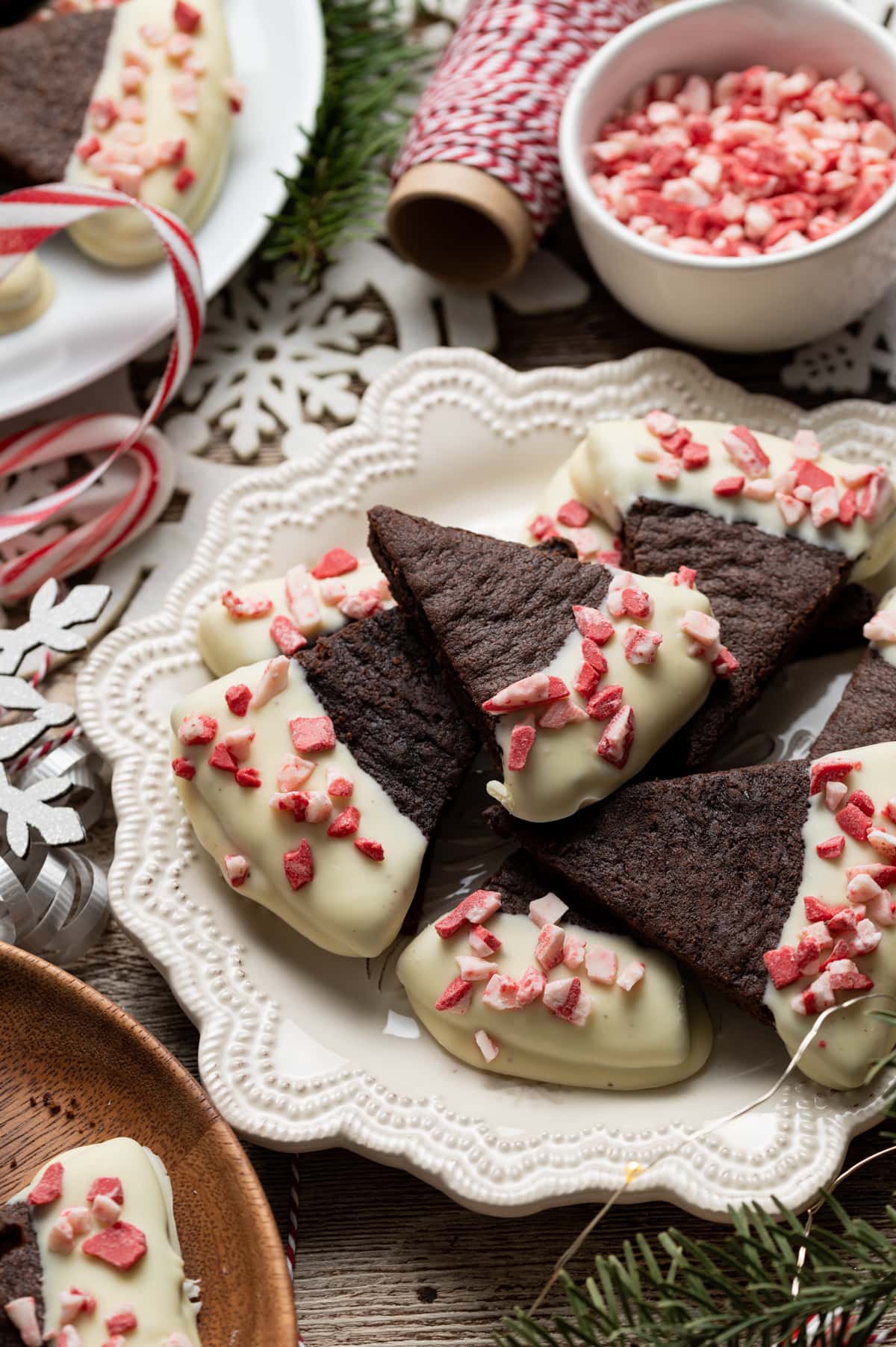 chocolate wedge shortbread cookies half dipped in white chocolate sprinkled with peppermint bits
