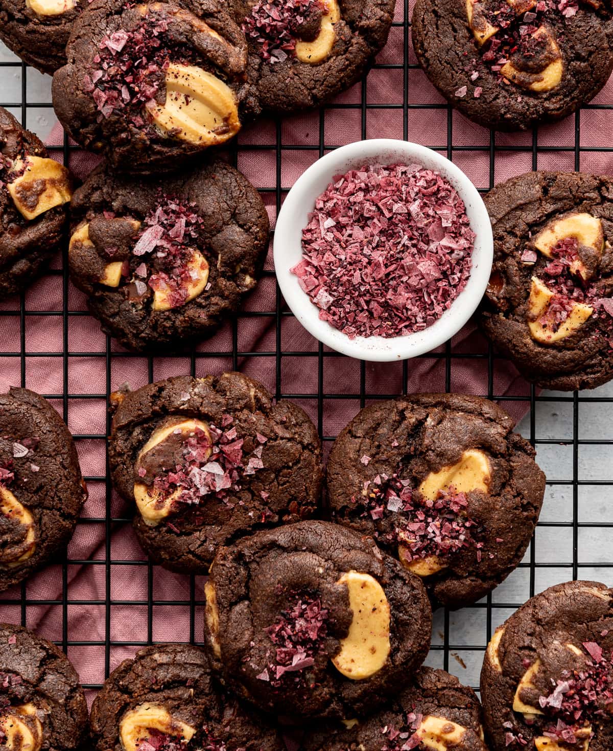 dark chocolate cookies with yellow passion fruit wafers and bowl of red hibiscus salt