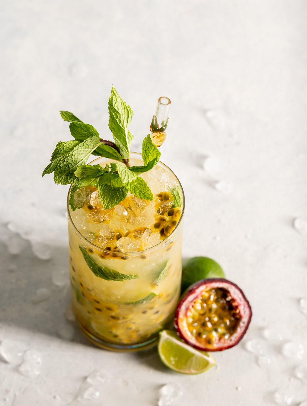 cocktail with passion fruit and mint slices of lime