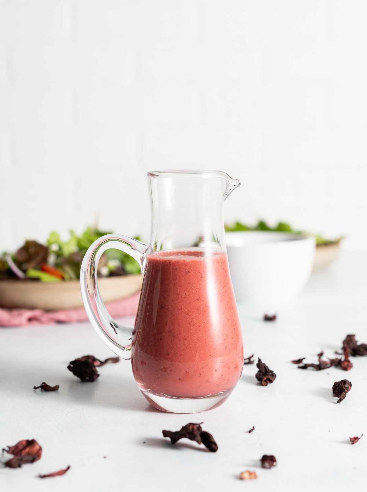 pink vinaigrette dressing in a glass bottle