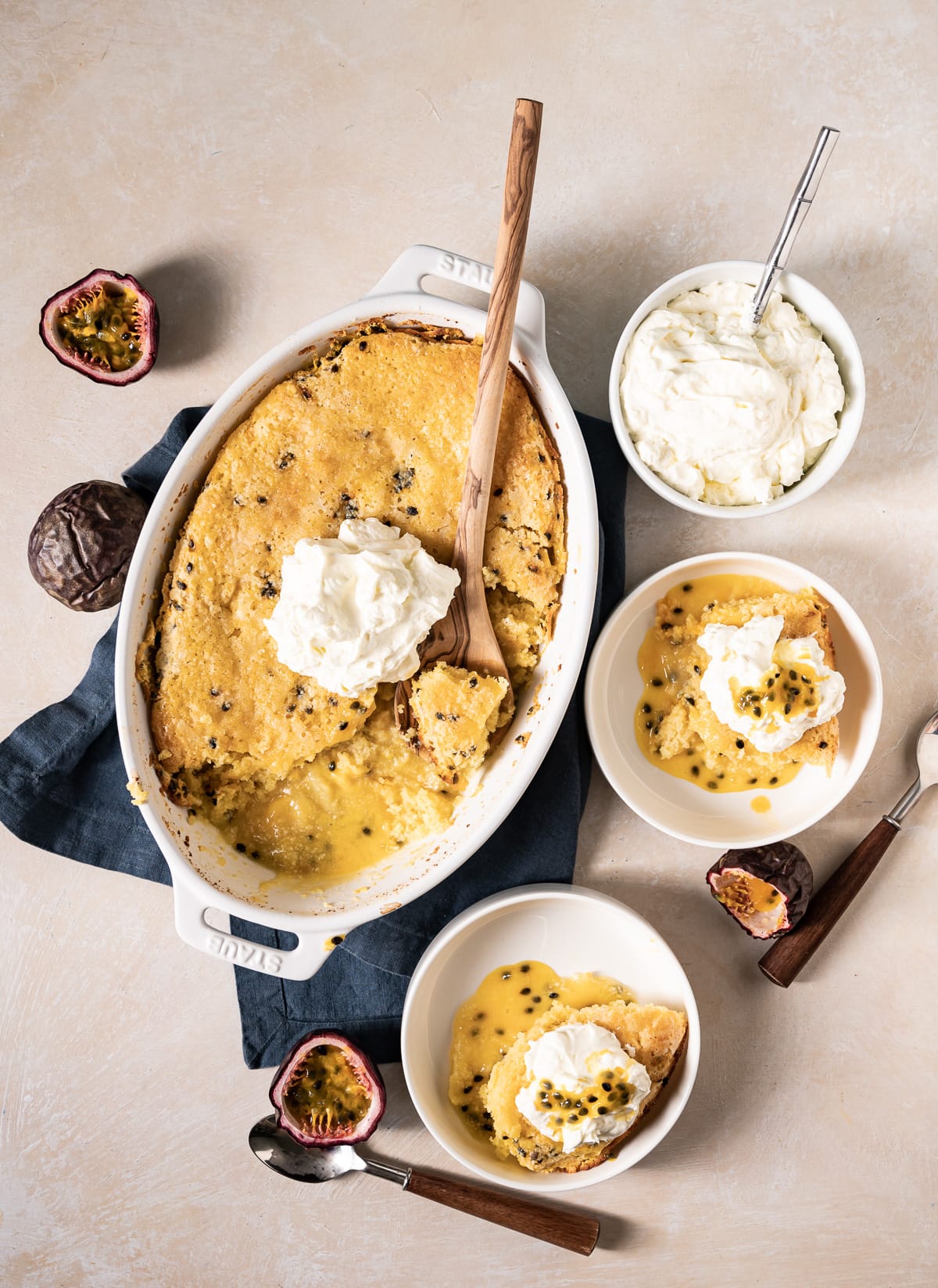 passion fruit self saucing pudding cake in white dishes with whipped cream
