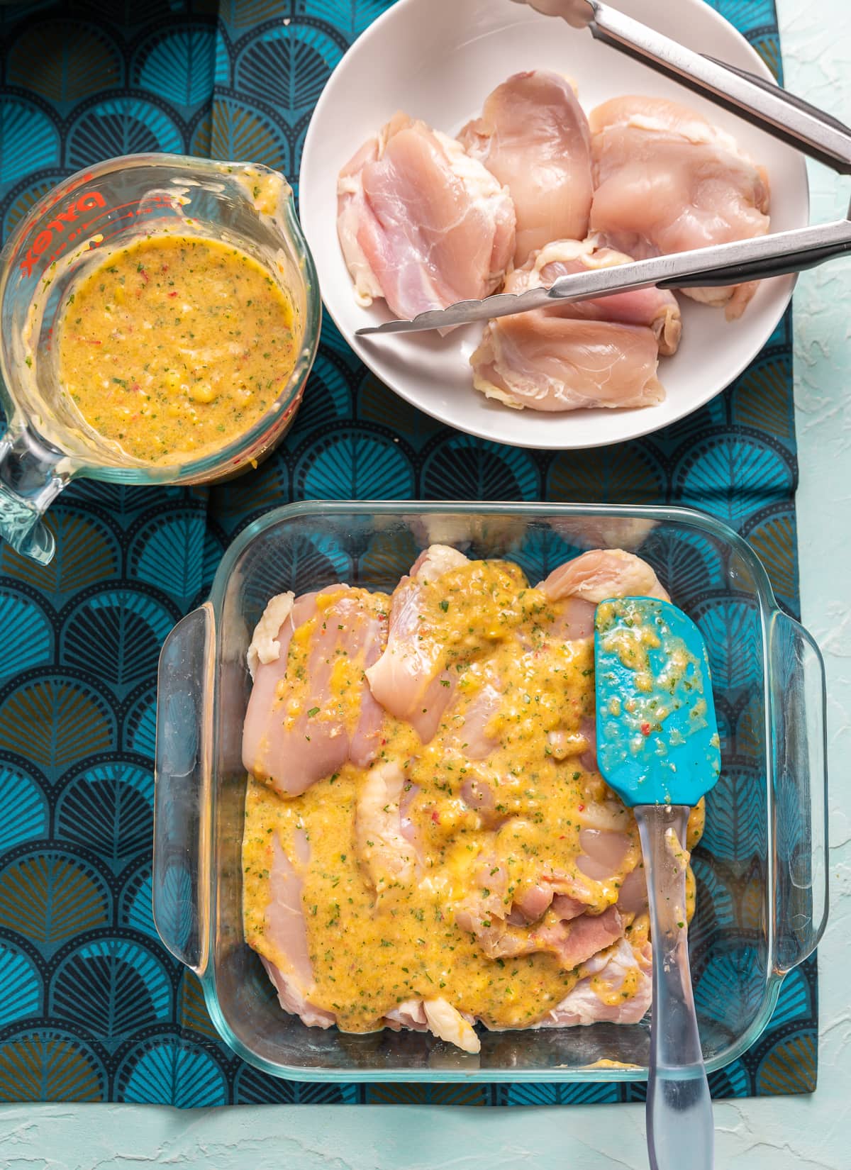 raw chicken in bowl and dish with yellow mango marinade