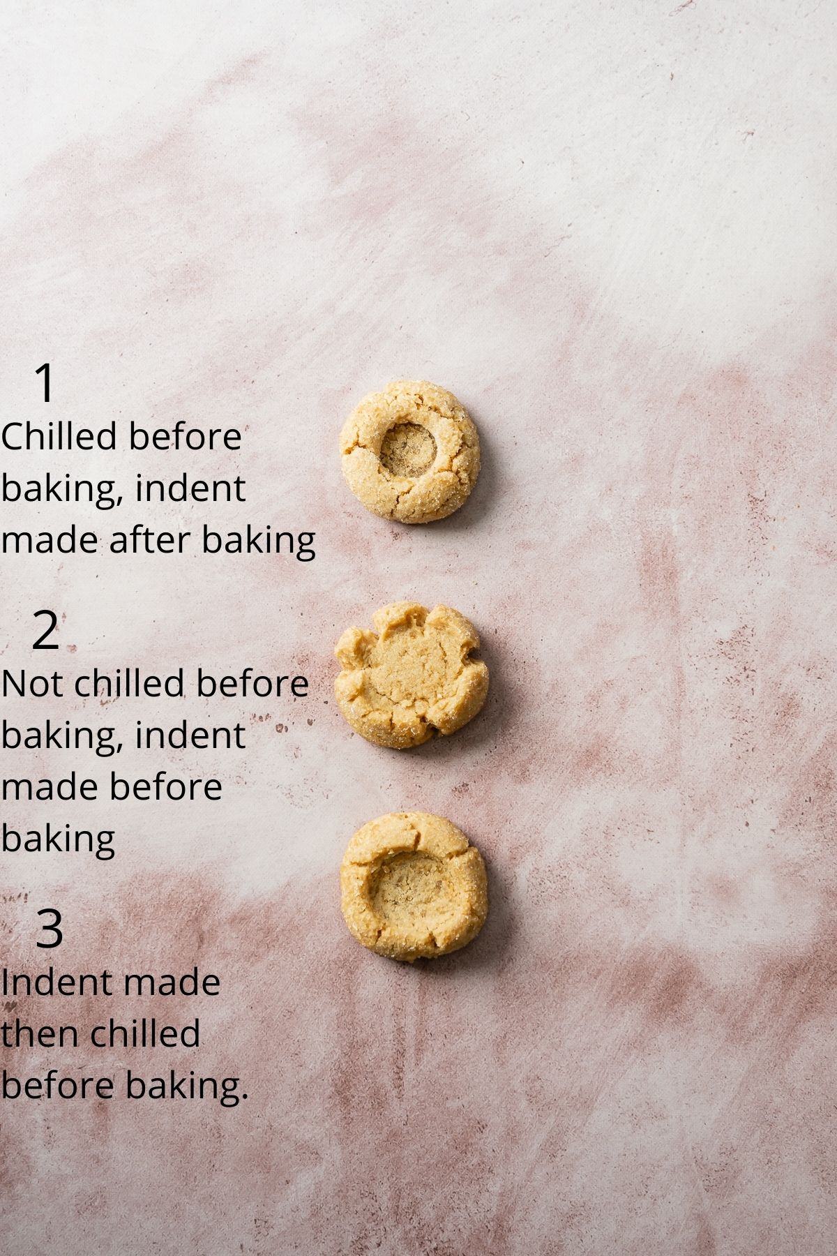 three peanut butter cookies with different sized indents in the middls