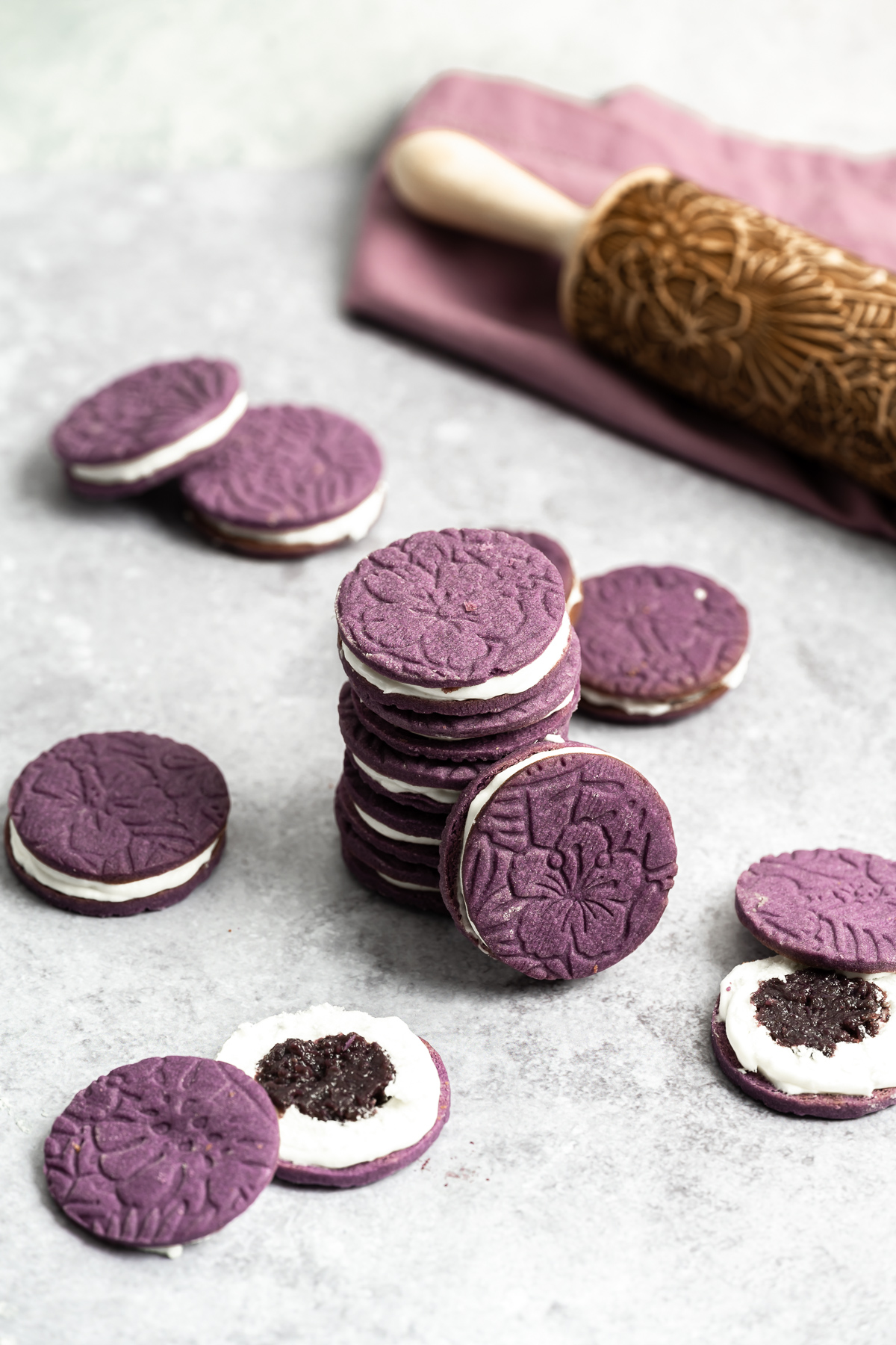 stack of embossed purple ube cookies with coconut frosting filling and ube halaya jam