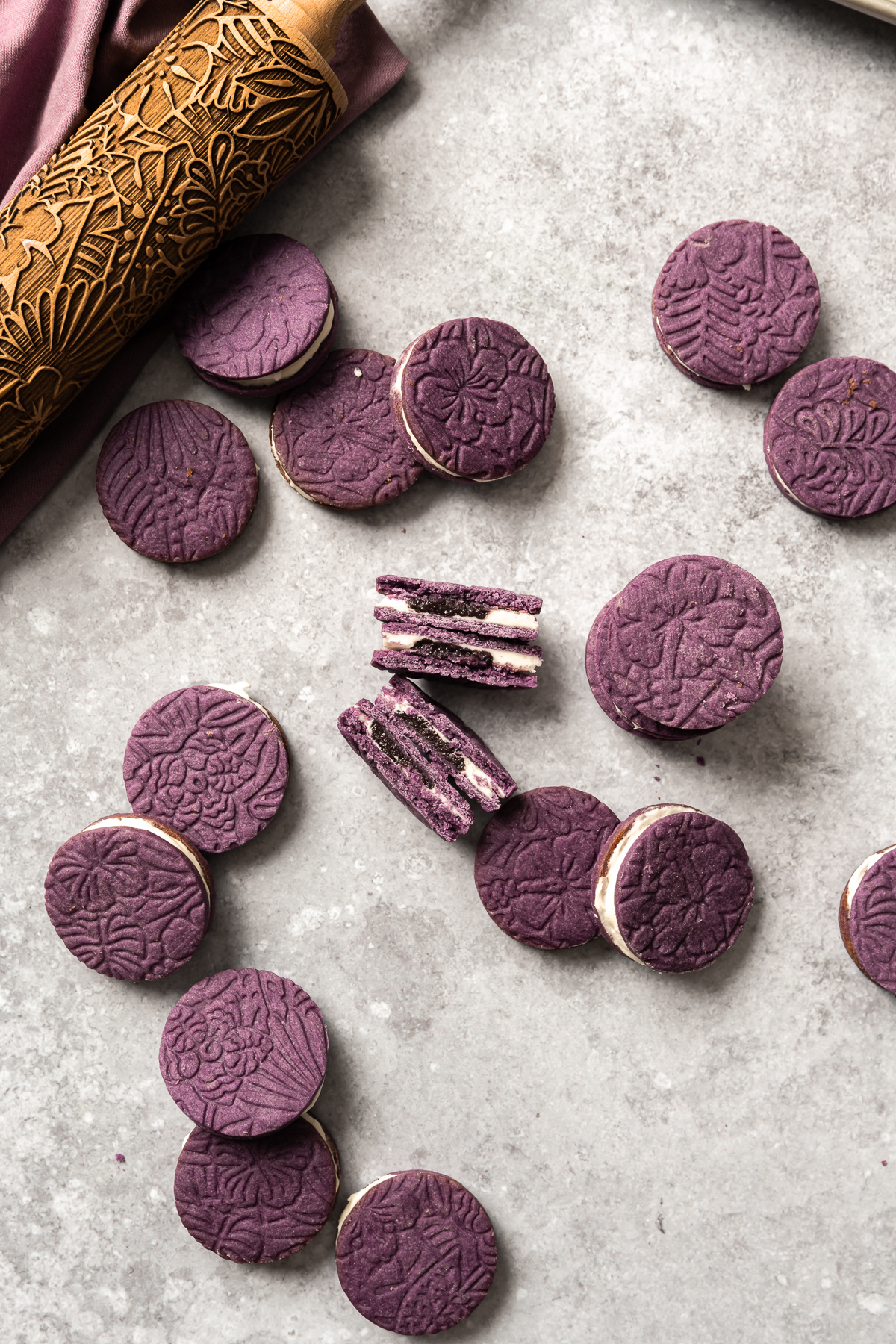 purple ube cookies with white coconut frosting filling tropical leaf embossed roller