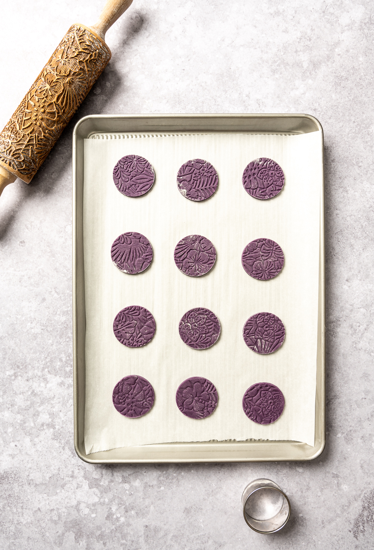 round cut out purple cookies on cookie sheet