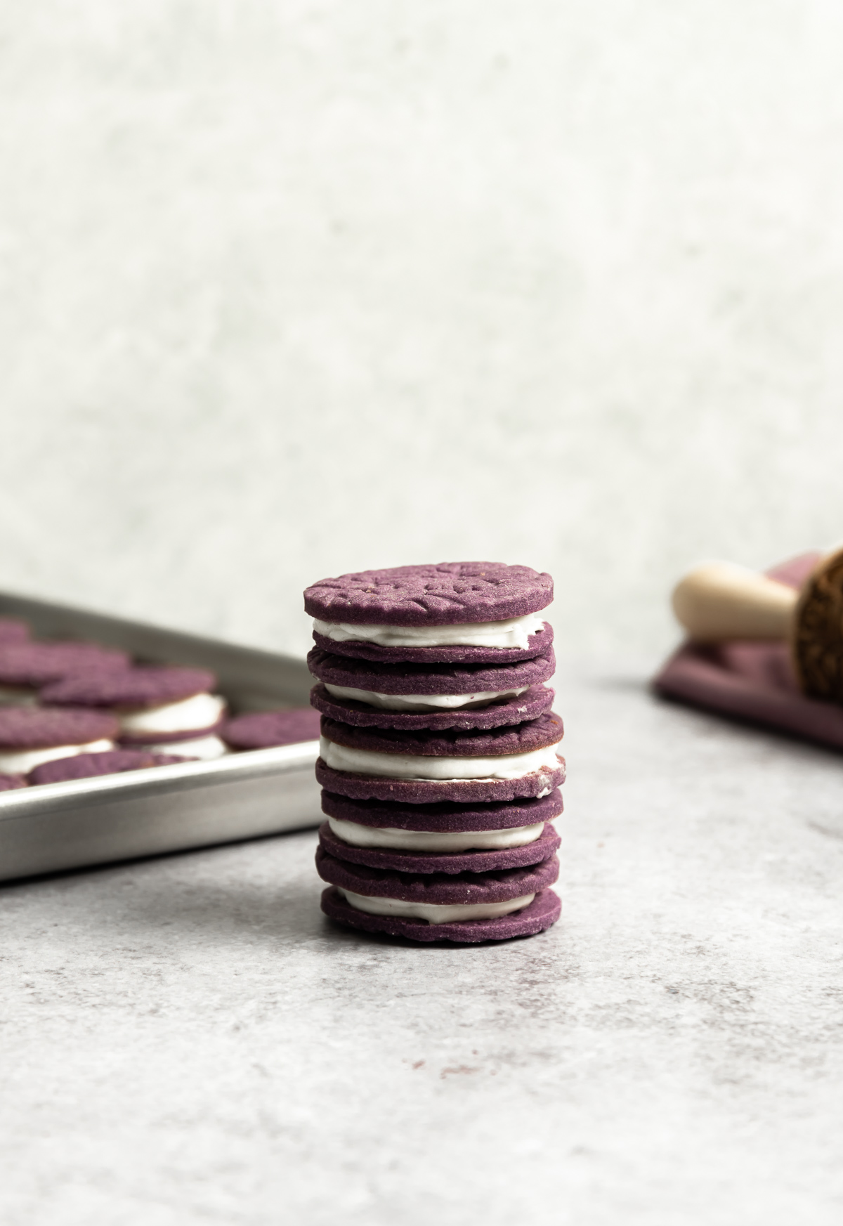 stack of purple ube sandwich cookies with coconut frosting filling