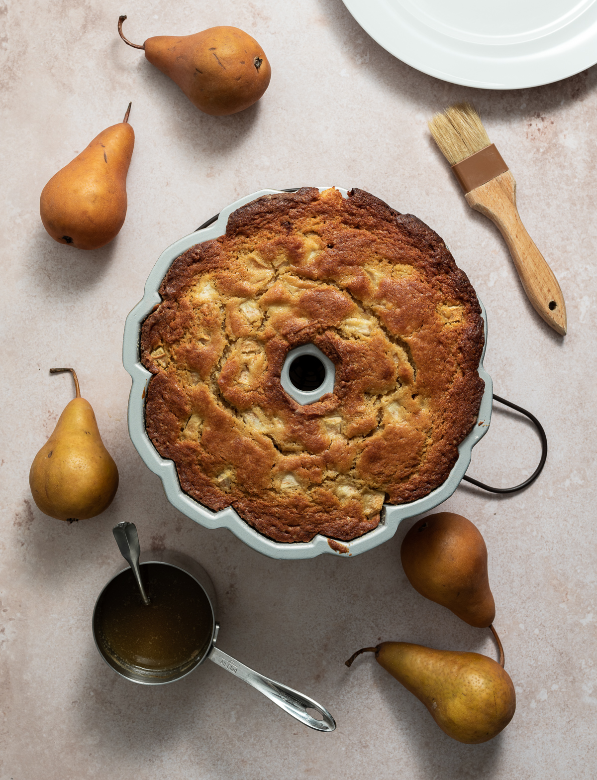 baked bundt cake in pan whole pears pastry brush