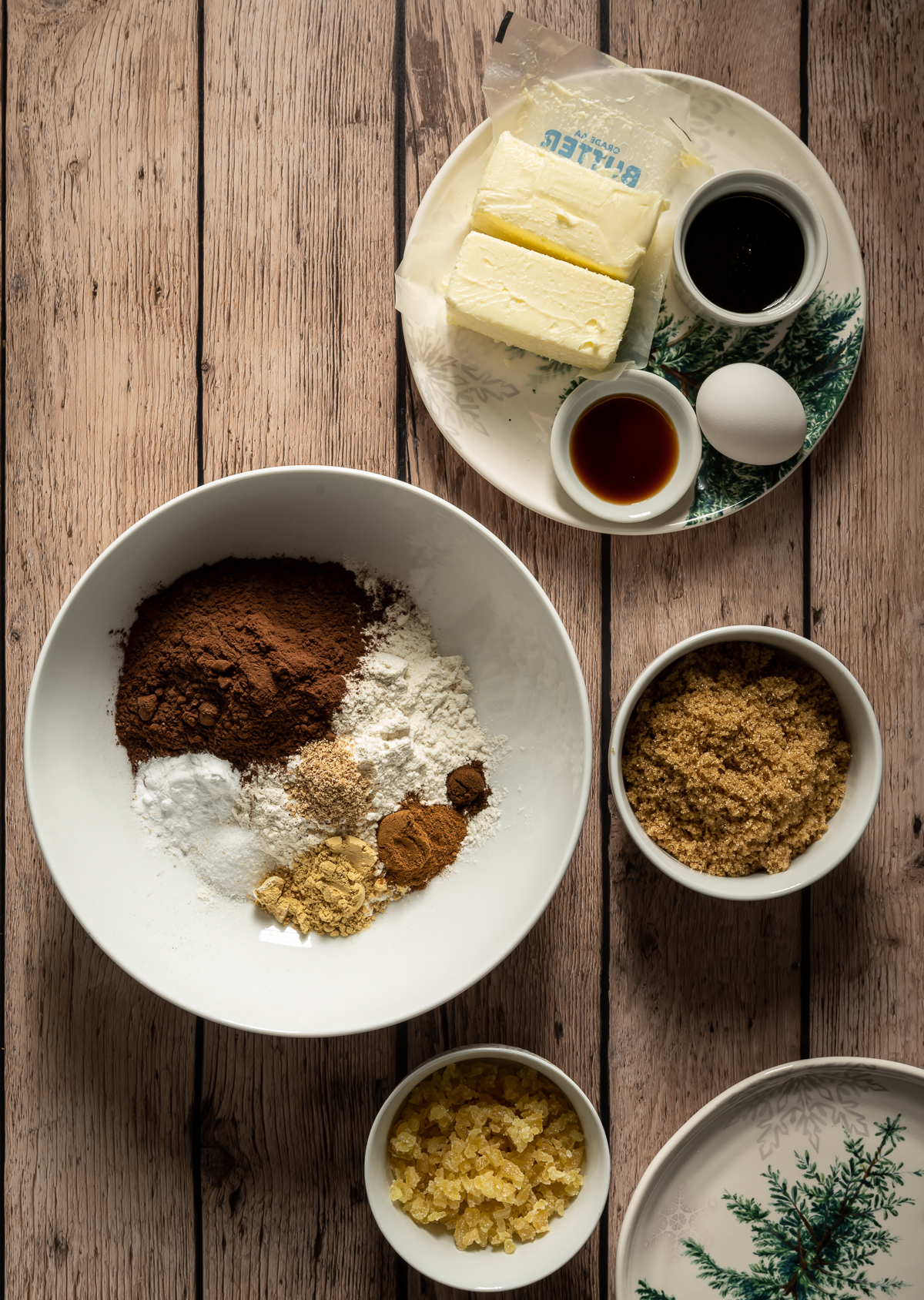 various ingredients for chocolate gingerbread cookies in bowls and plates 