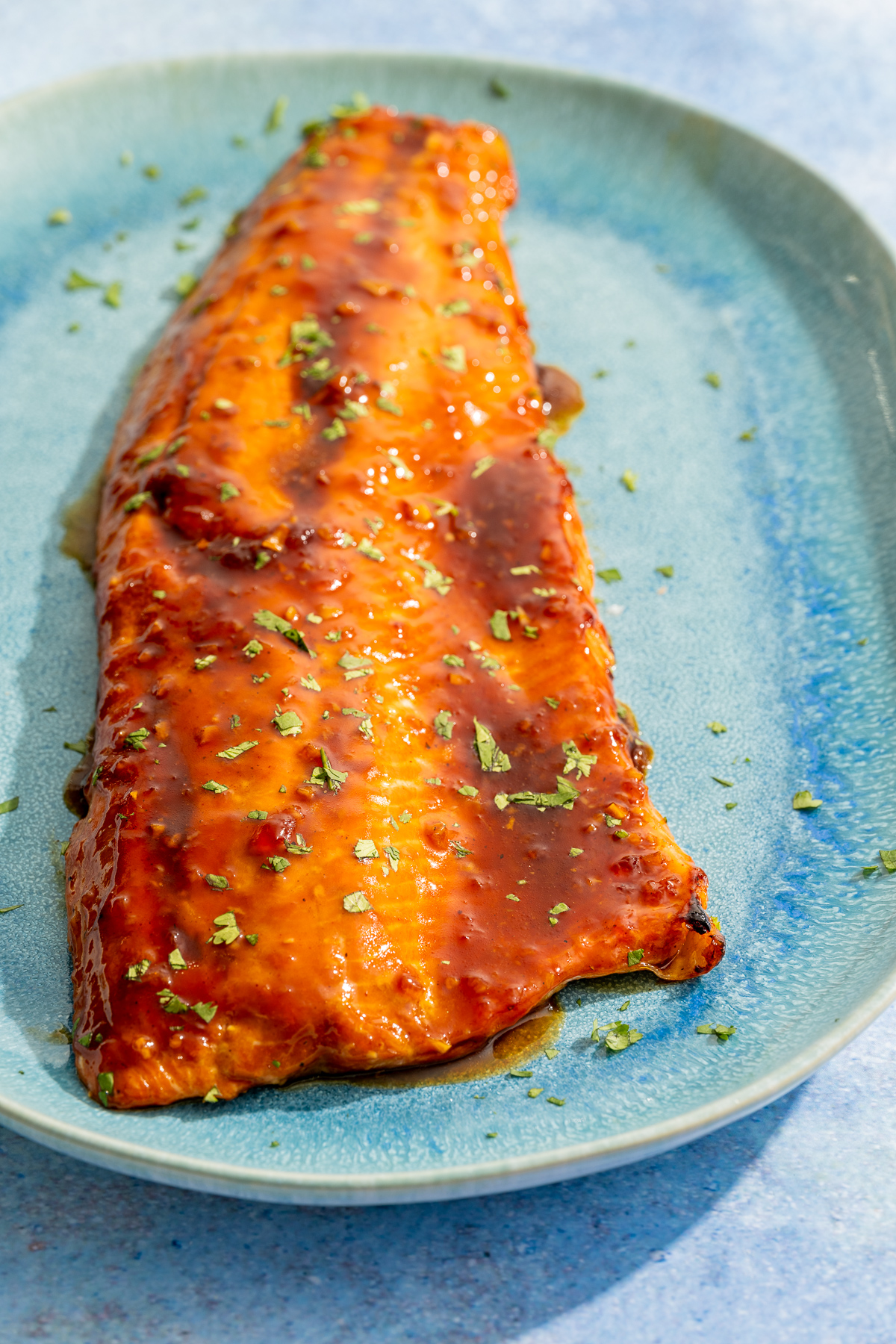 baked wild Alaskan coho hot honey glazed salmon on a blue platter 