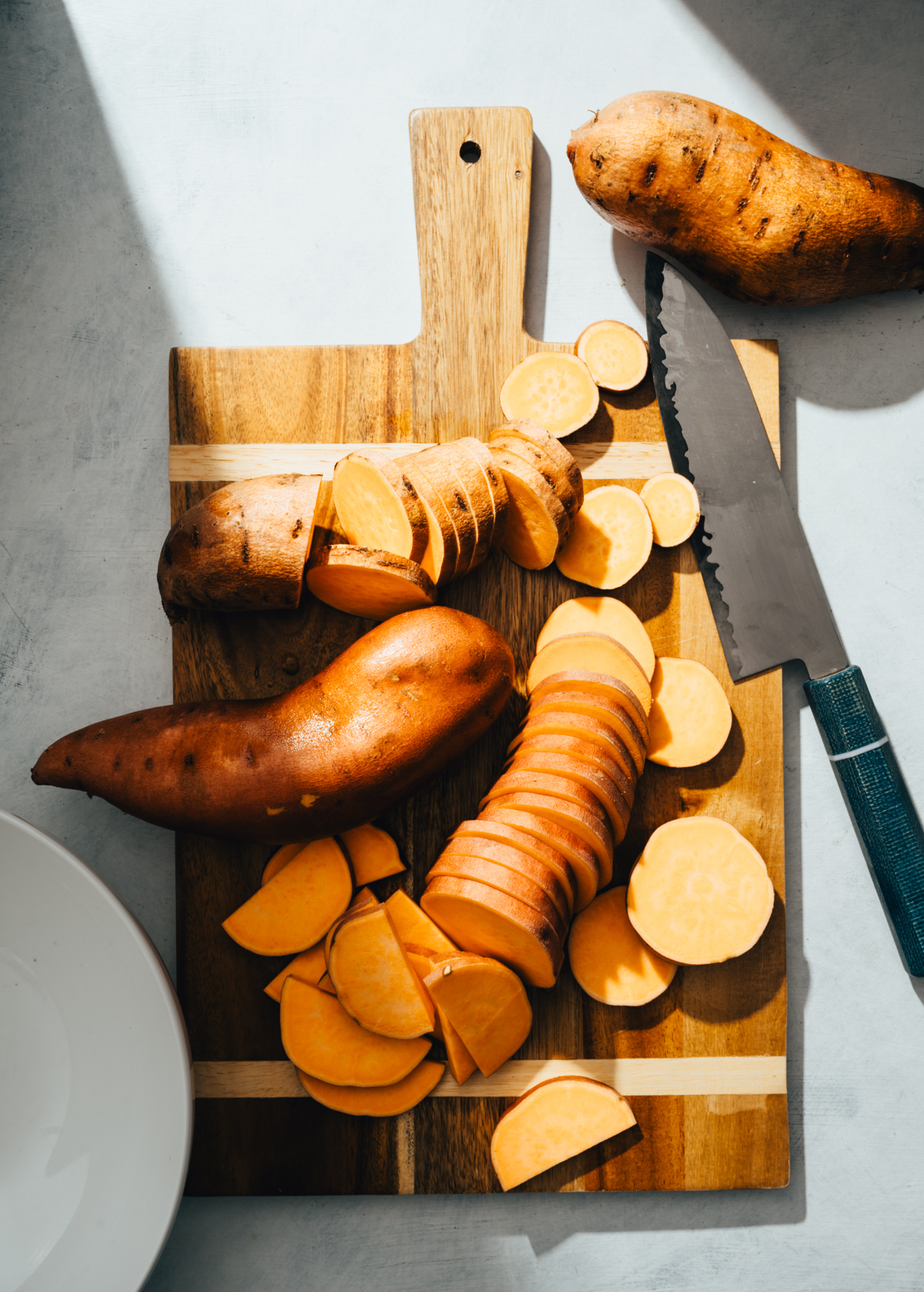sweet potatoes slices on a cutting board