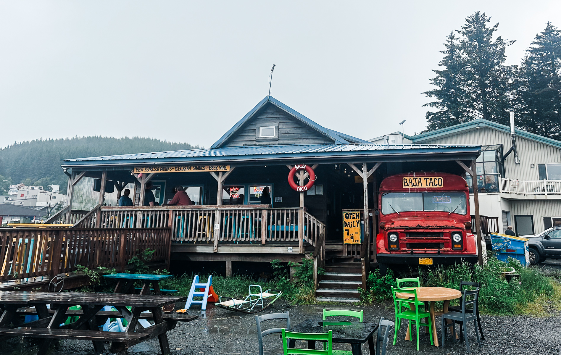 baja tacos restaurant in cordova alaska red school bus blue roof building various chairs around tables