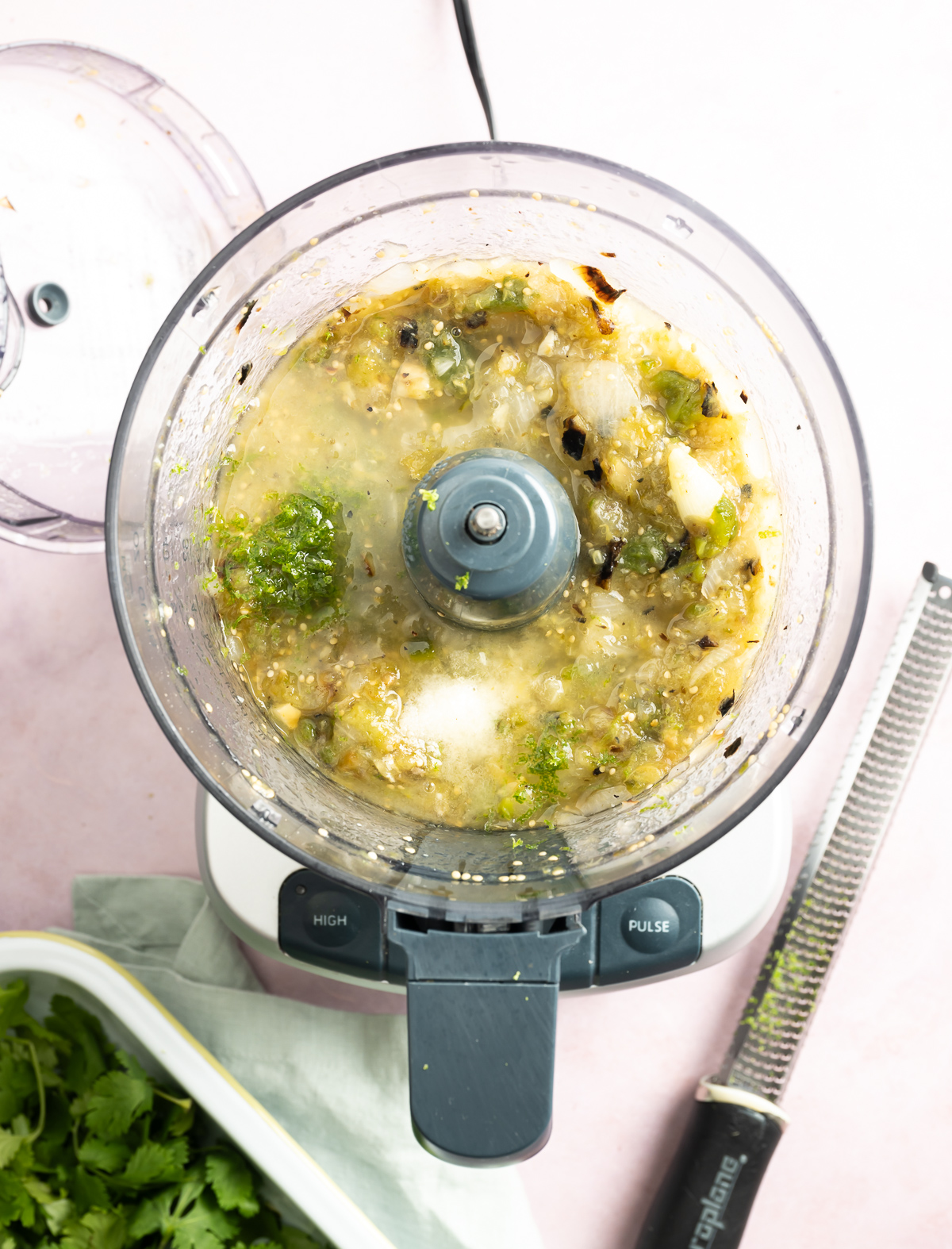 chunky pureed green salsa in food processor with salt and lime zest