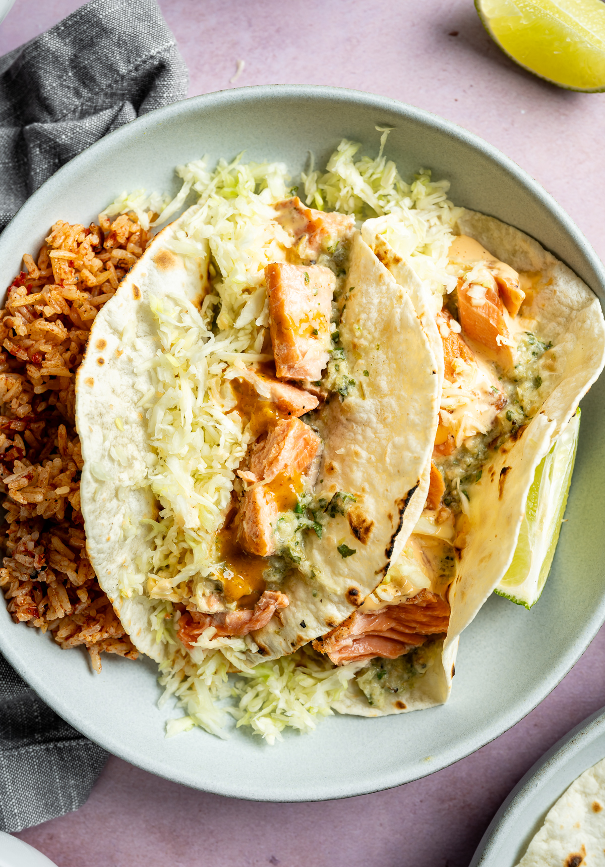grilled salmon tacos with salmon shredded green cabbage red rice lime halves