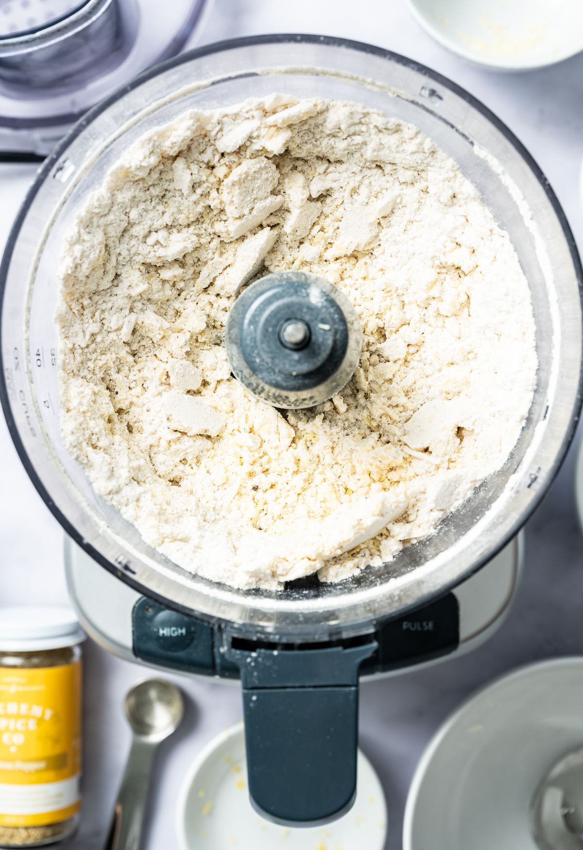 food processor with pulsed flour, cheese and olive oil