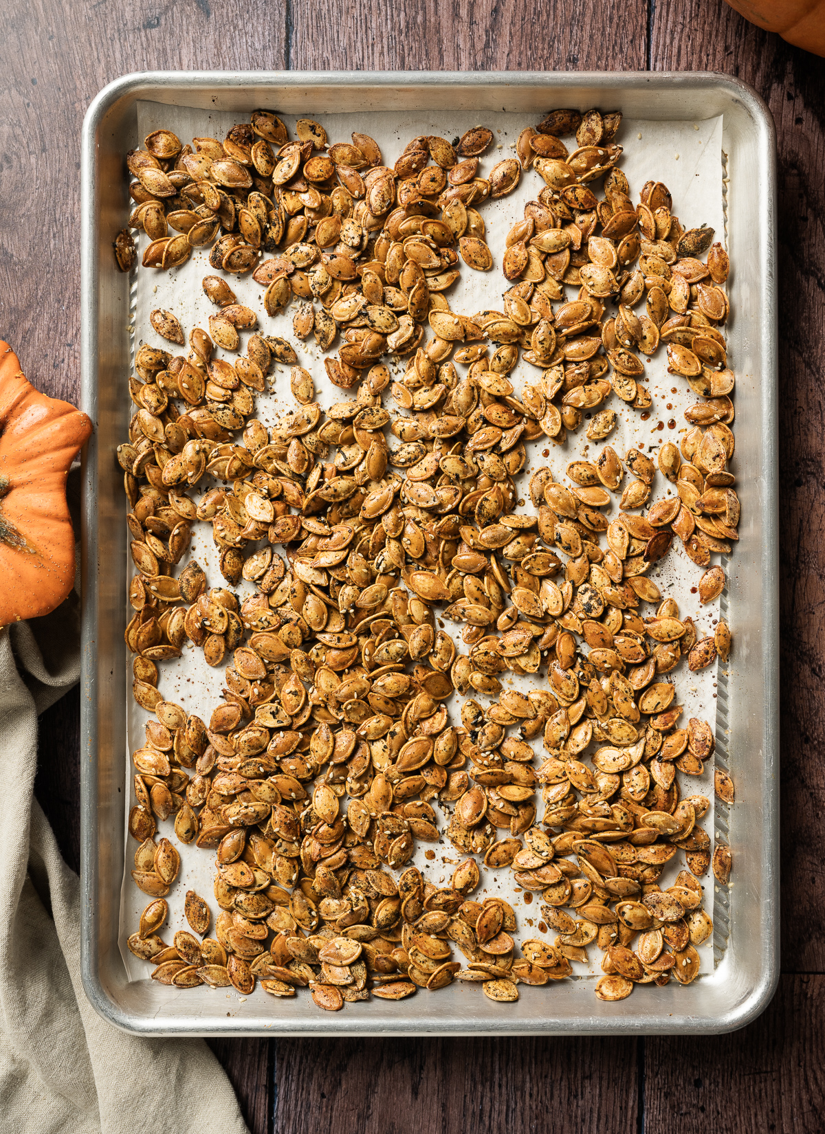 baking sheet with golden brown roasted pumpkin seeds with furikake seasoning 
