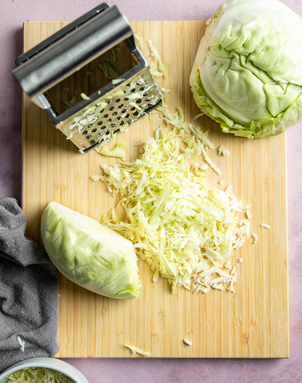 shredded green cabbage on cutting board