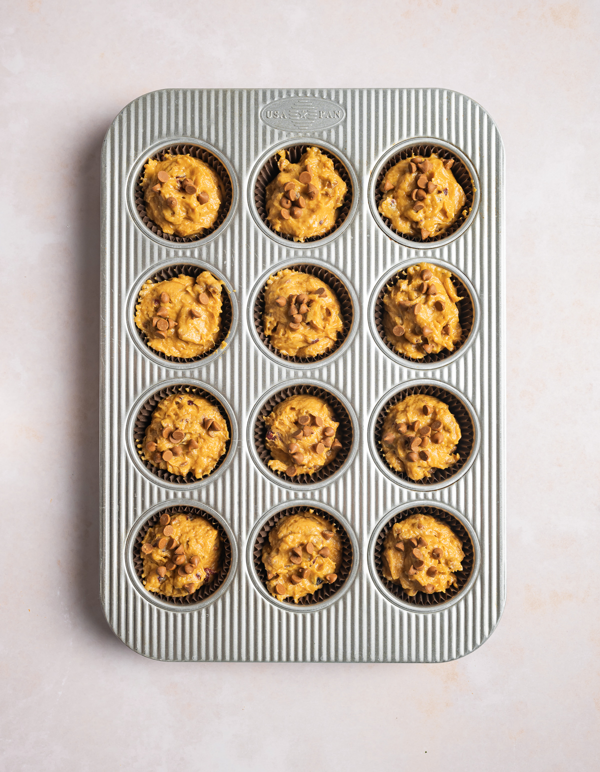 muffin batter in a 12 cup muffin tin