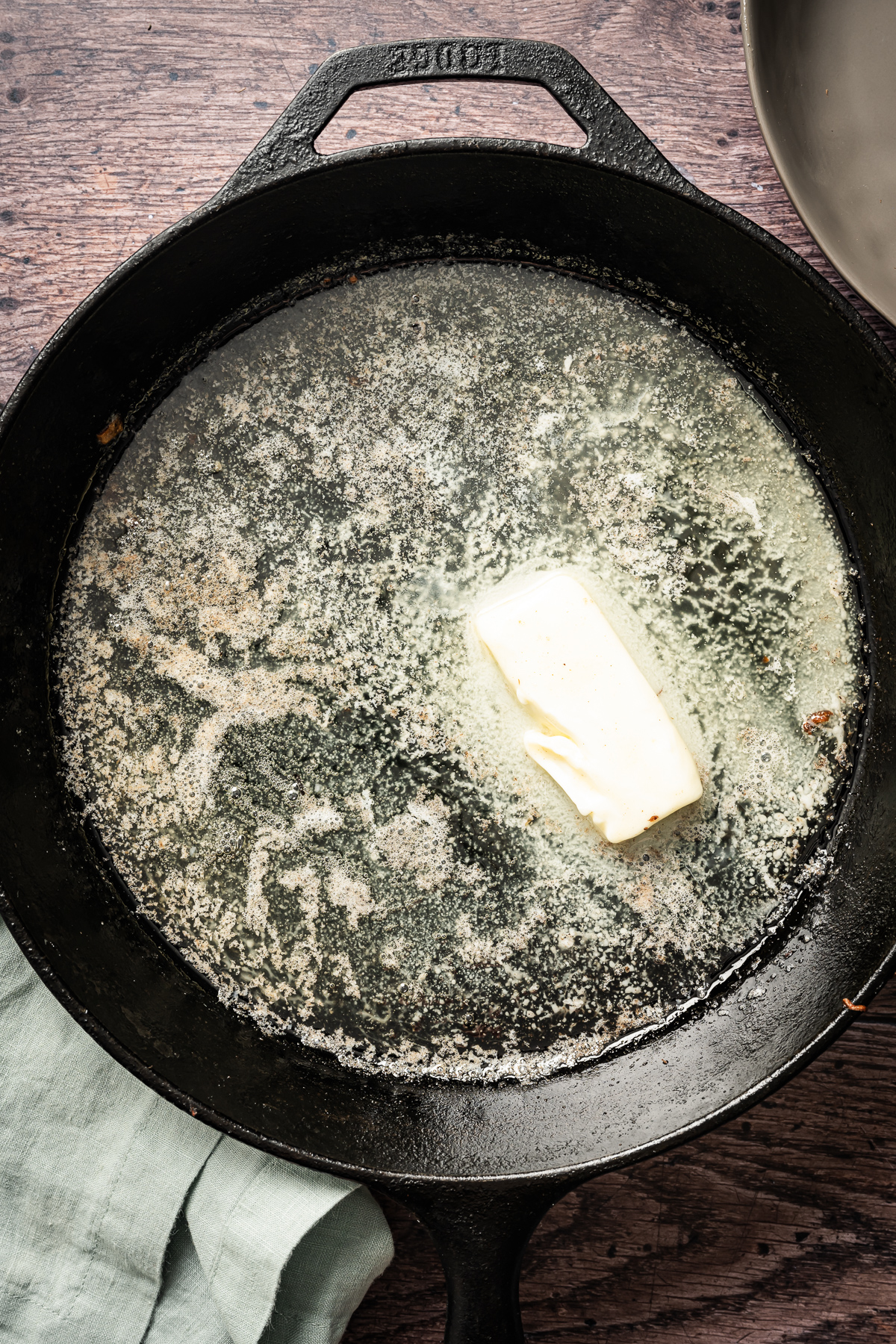 butter being melted in cast iron pan