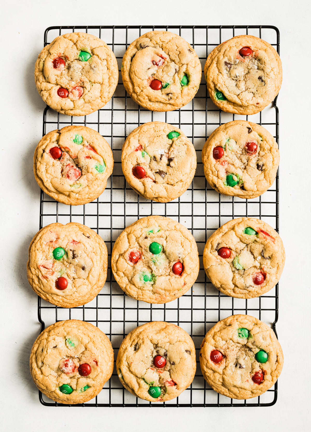 cookies with red and green M&Ms on a wire cooling rack