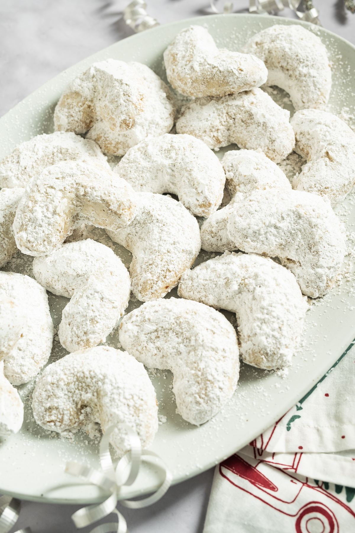 white crescent shaped cookies on a platter
