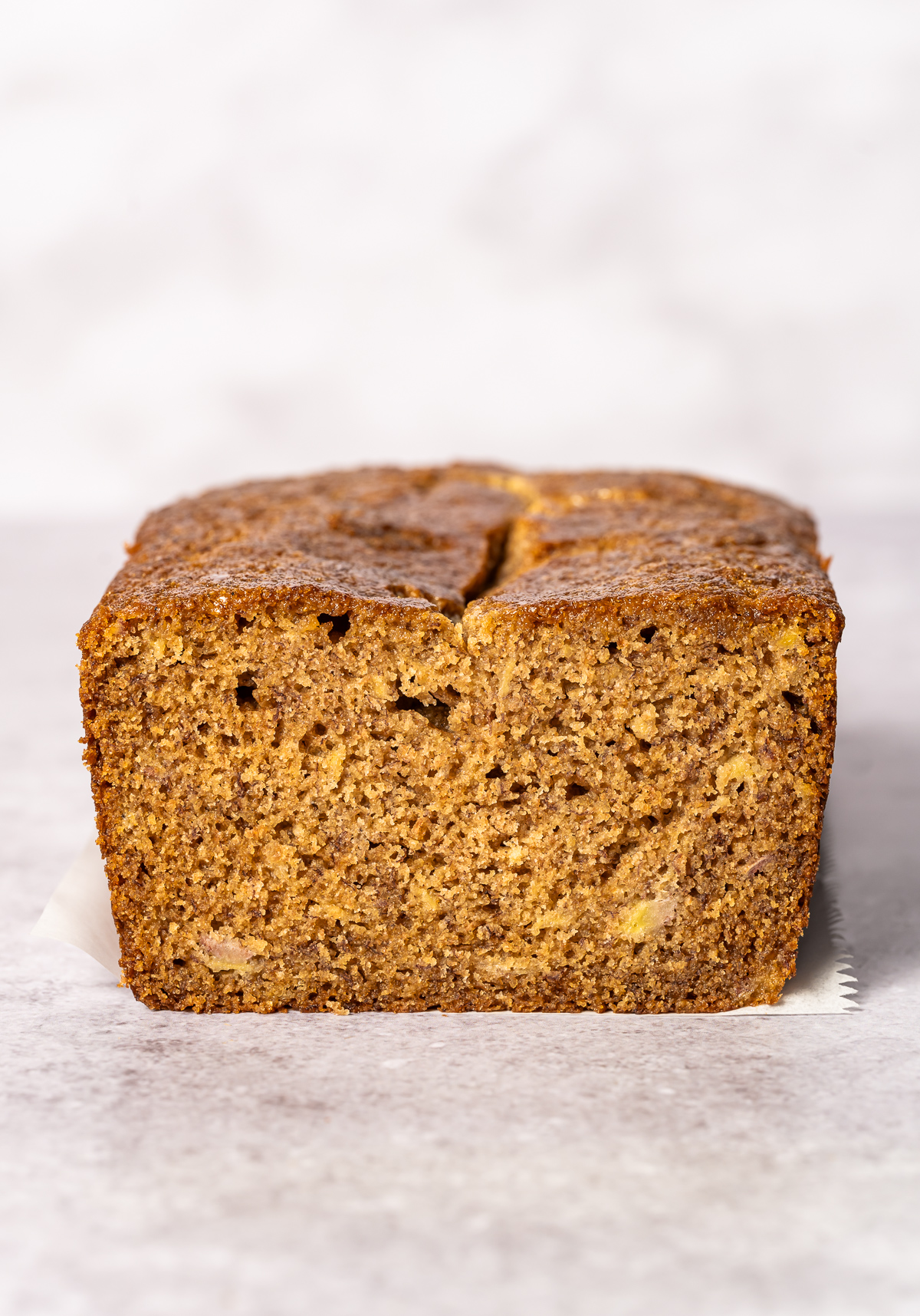 loaf of spelt banana bread with a slice cut out 