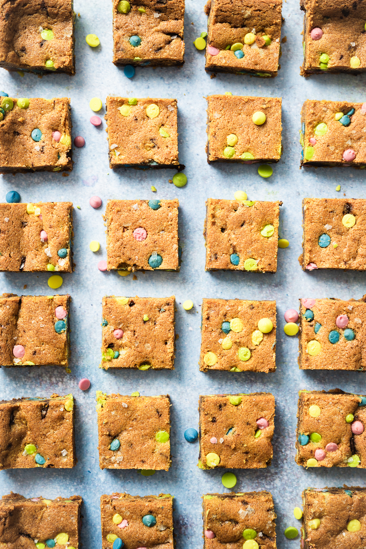 chocolate chip cookie bars cut into squares with rainbow chips