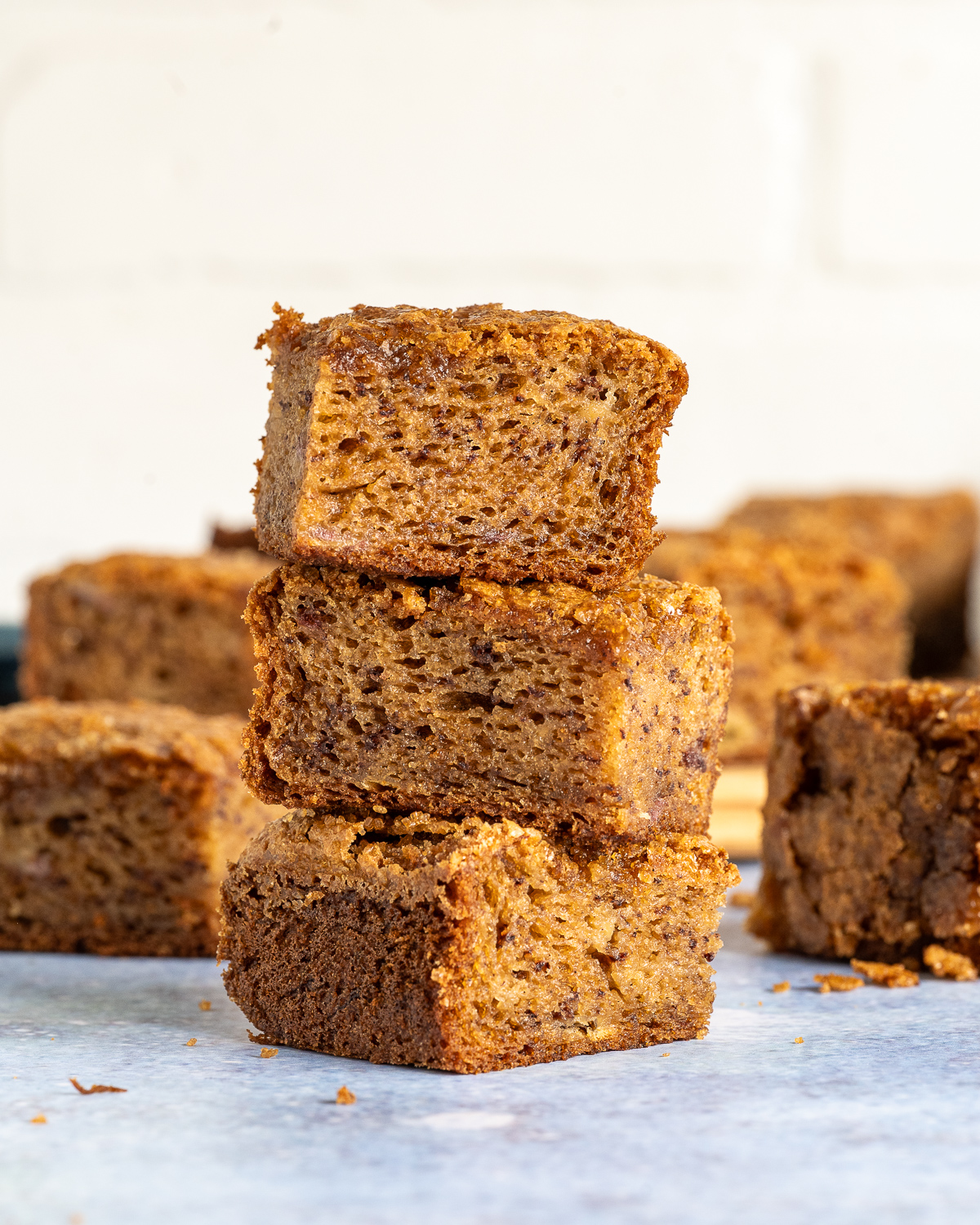 three squares of banana bread butter mochi stacked on top of each other 